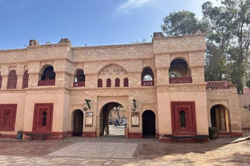 A historic building with arched doorways and a central entrance. 5