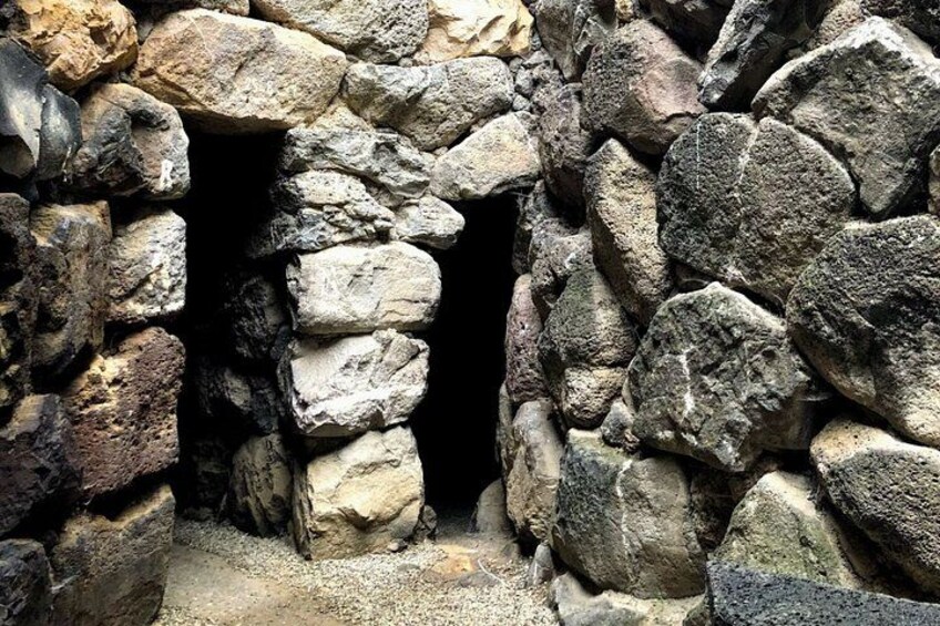 A stone wall with a narrow opening. 5