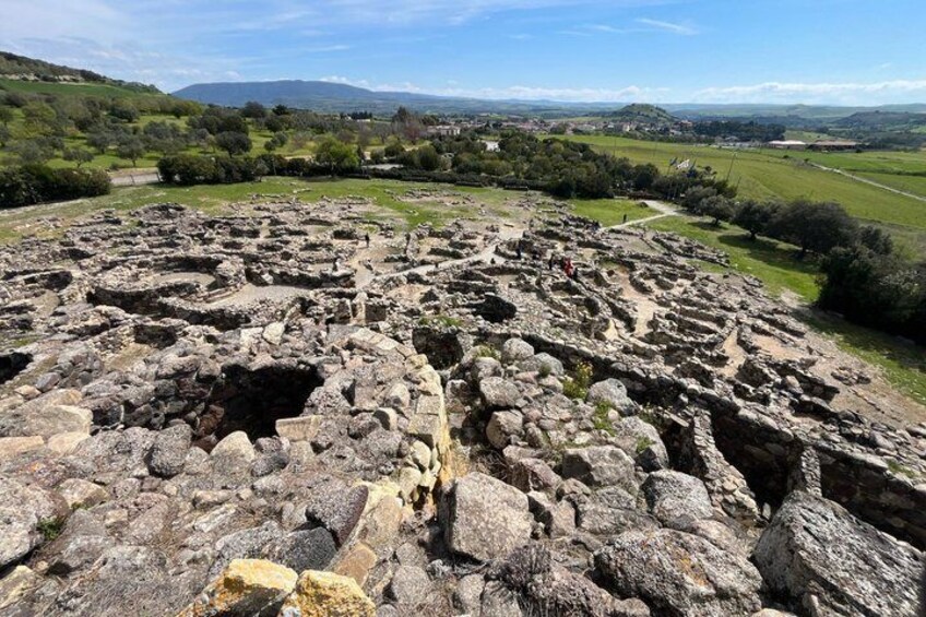 Ancient ruins with stone structures and a clear view of the surrounding countryside. 3
