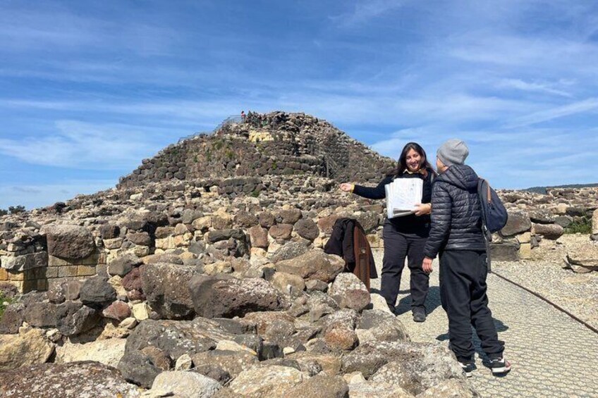 A rocky archaeological site with ruins and a clear sky. 1