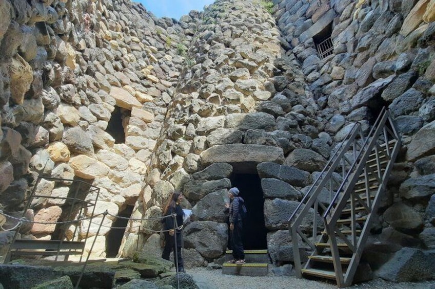 A stone structure with a staircase leading to an entrance. 2