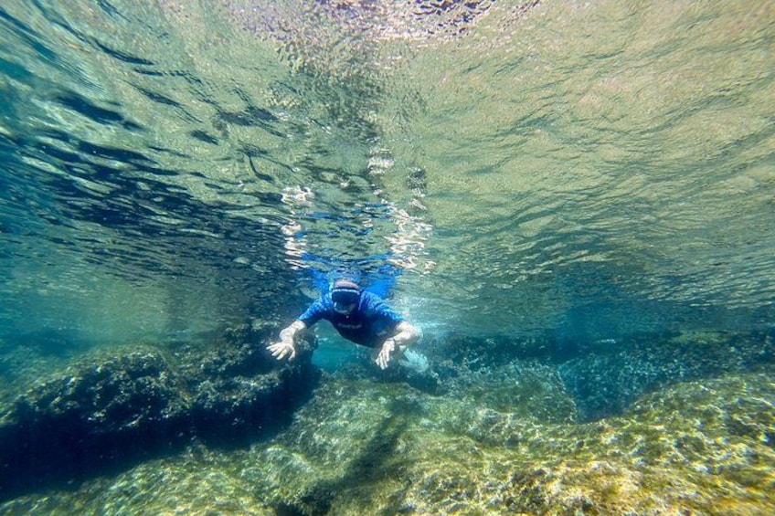 A person swimming underwater. 3