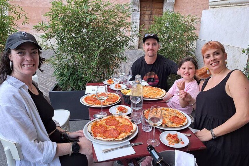 Enjoying pizza outdoors in Rome. 2