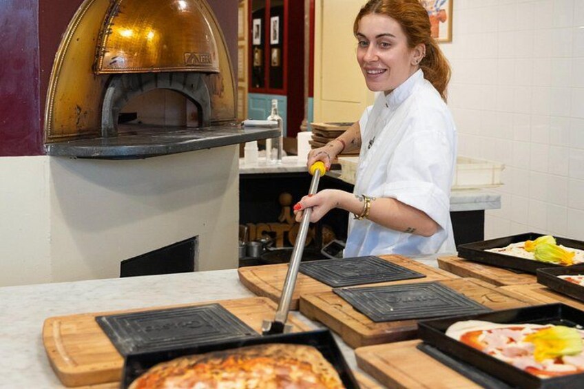 Pizza coming out of the oven. 3