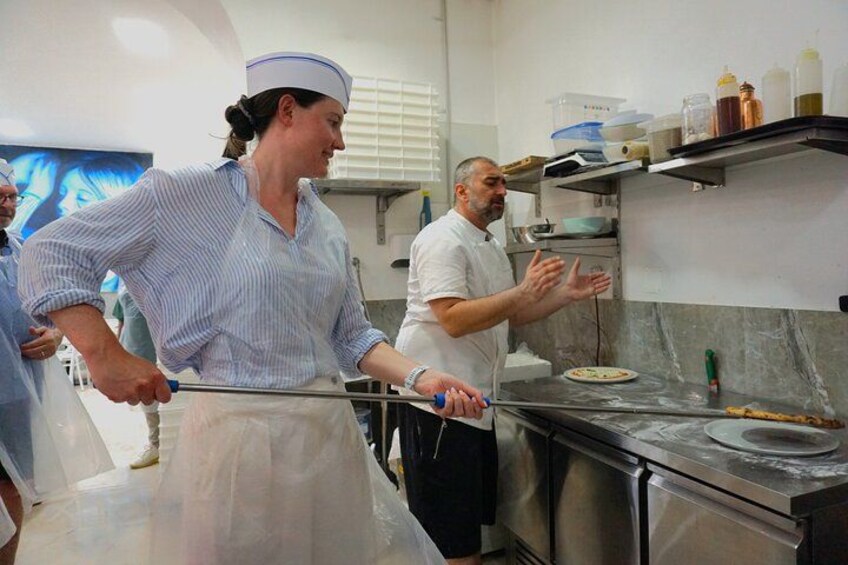 Putting the pizza in the plate, fresh out of the oven! 2
