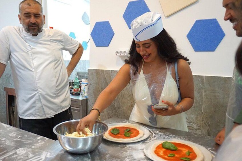 Putting basil on the pizza. 5