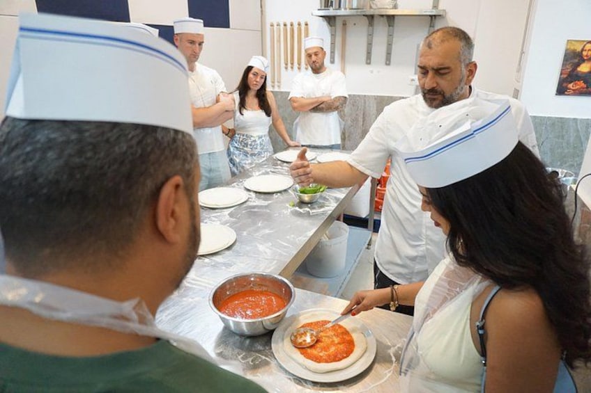 Putting tomato sauce on the pizza! 4
