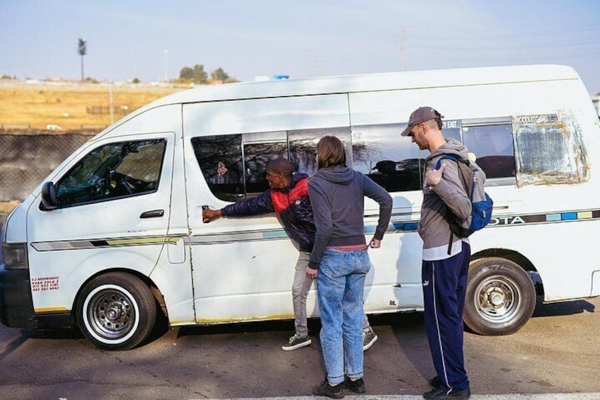 A white van with the word 'GTA' on the side parked on a road. 2