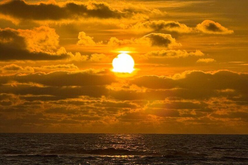 Un coucher de soleil sur l’océan, avec des nuages. 4