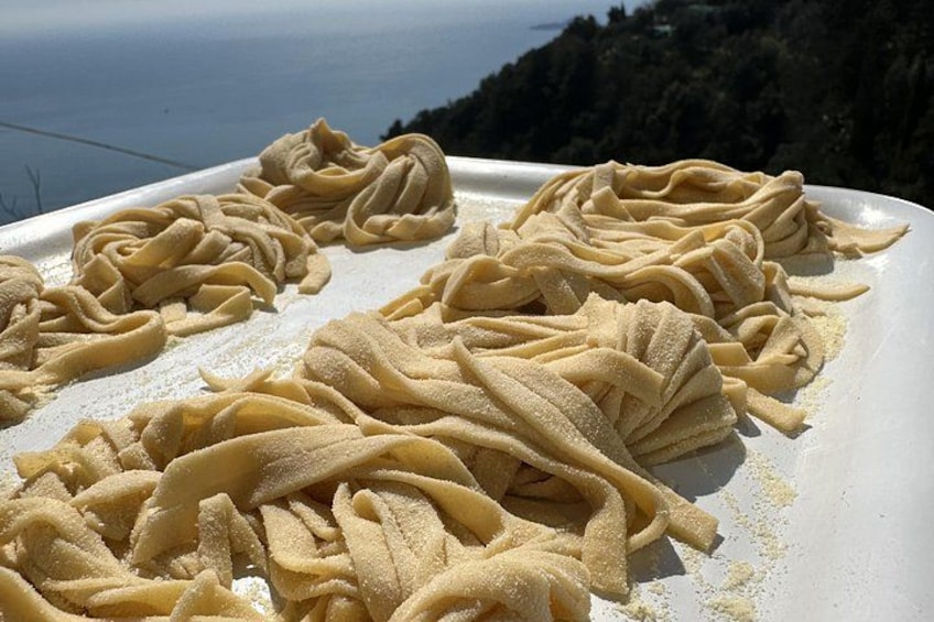 Pasta on a white plate with a scenic background. 2