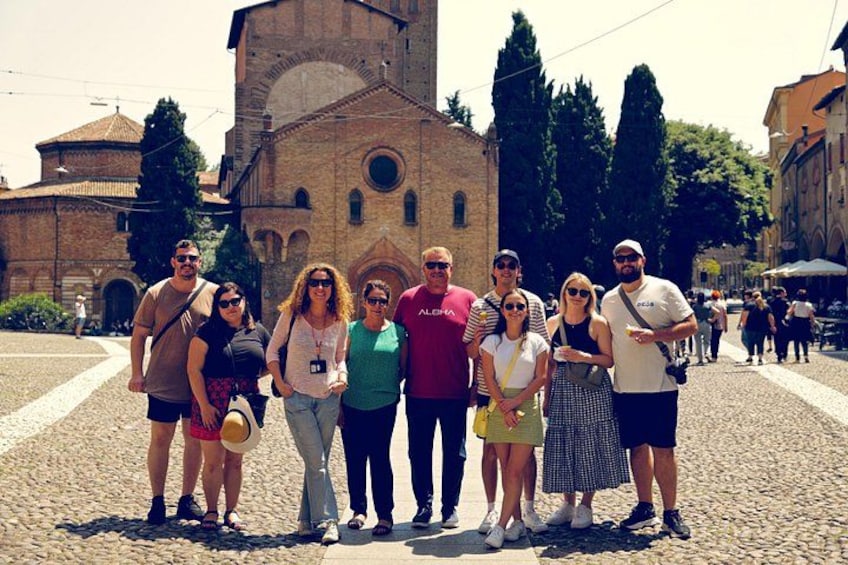 A group of people standing in front of a historic building with a clock tower. 3