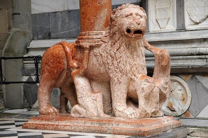 A stone sculpture of a lion and a cub in a classical architectural setting. 5