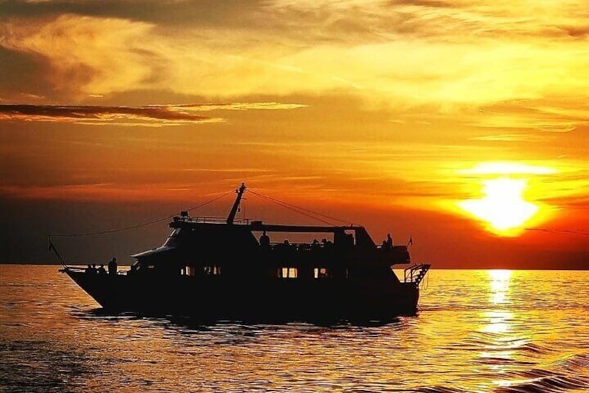 A boat on calm water during sunset. 4