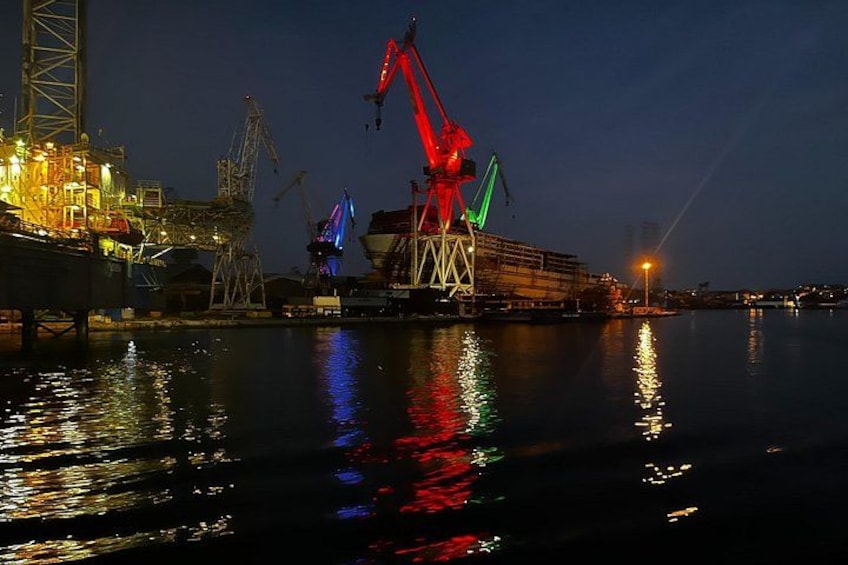 An offshore oil platform at night with cranes and industrial structures. 3