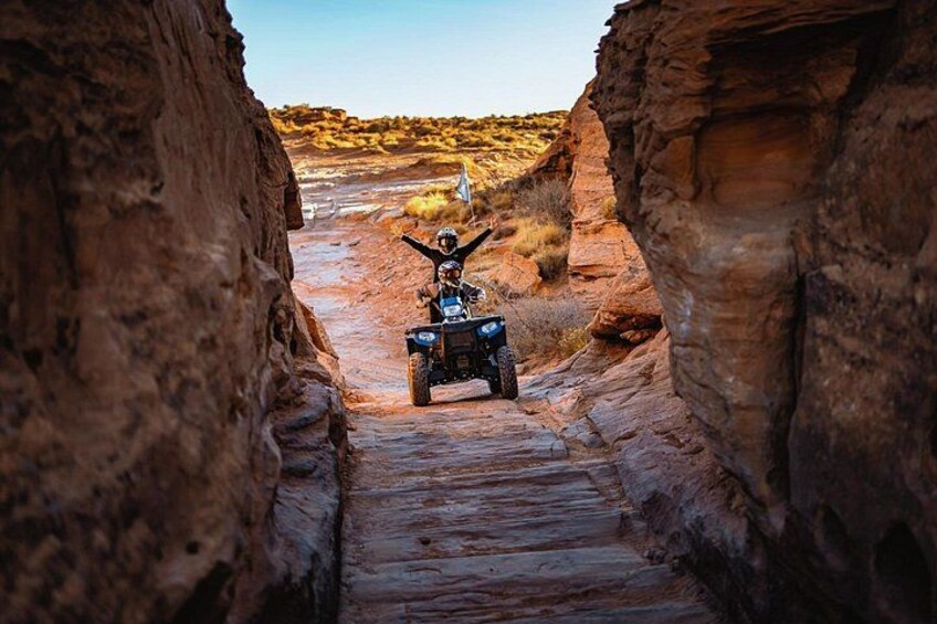 An ATV navigating a narrow canyon path. 2