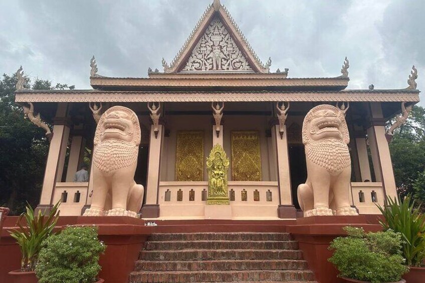 A temple with a golden statue in the center, flanked by two lion statues. 3