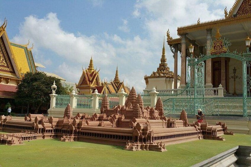 A temple complex with multiple structures, including a central building with a golden roof and smaller buildings with pointed roofs. 4