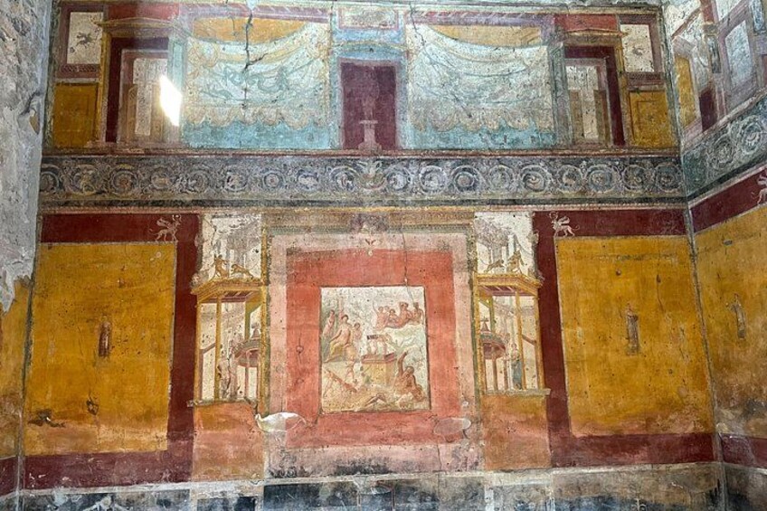 A fresco with architectural elements and a central scene. 3