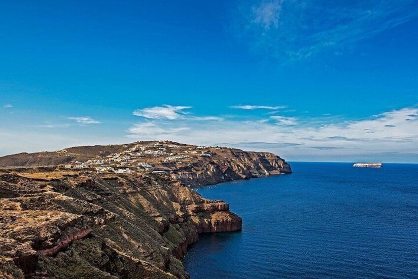 A coastal landscape with cliffs, a body of water, and a distant ship. 5