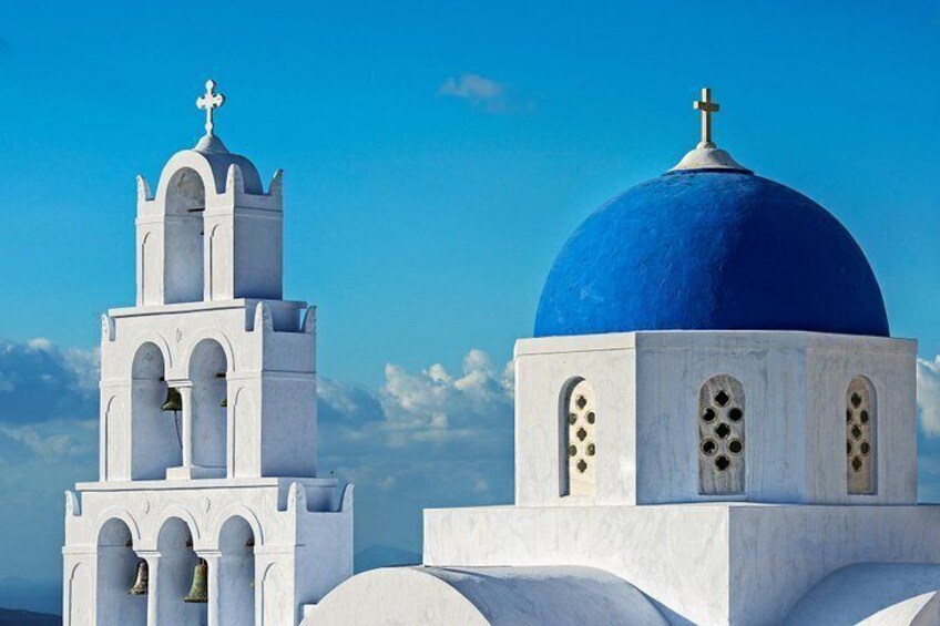 A white church with a blue dome and a bell tower under a clear blue sky. 3