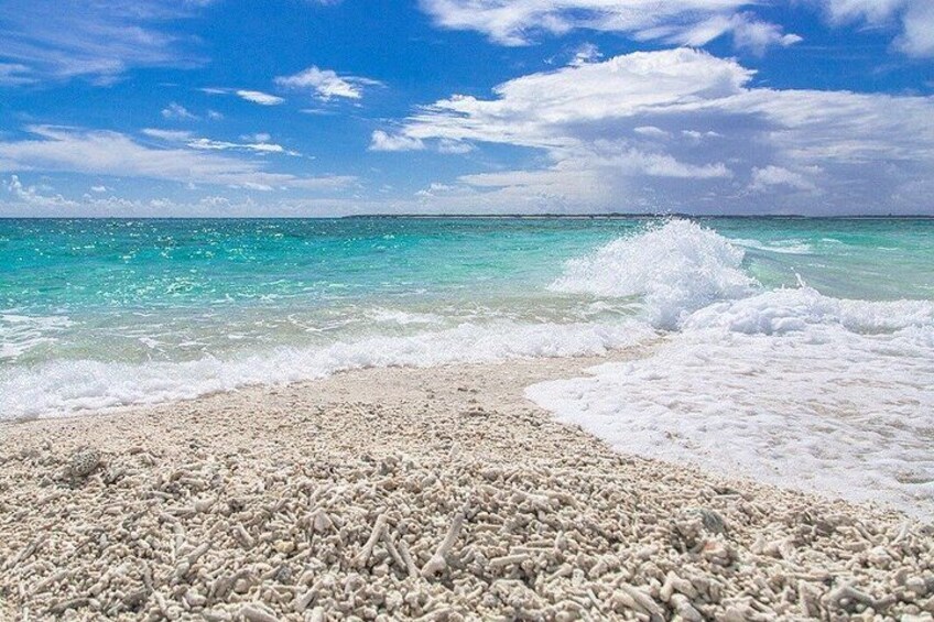 A beach with white sand and turquoise water. 3