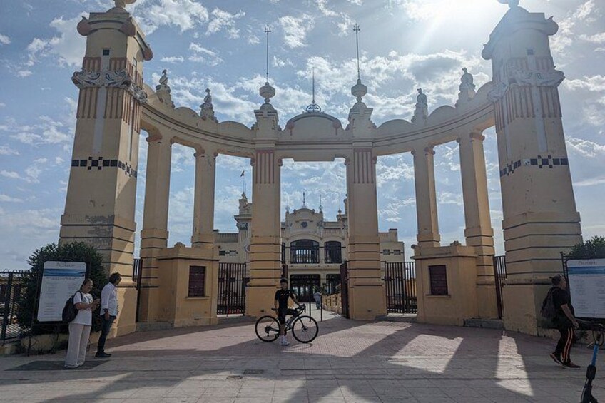 A historic gate with columns and a bicycle in the foreground. 2