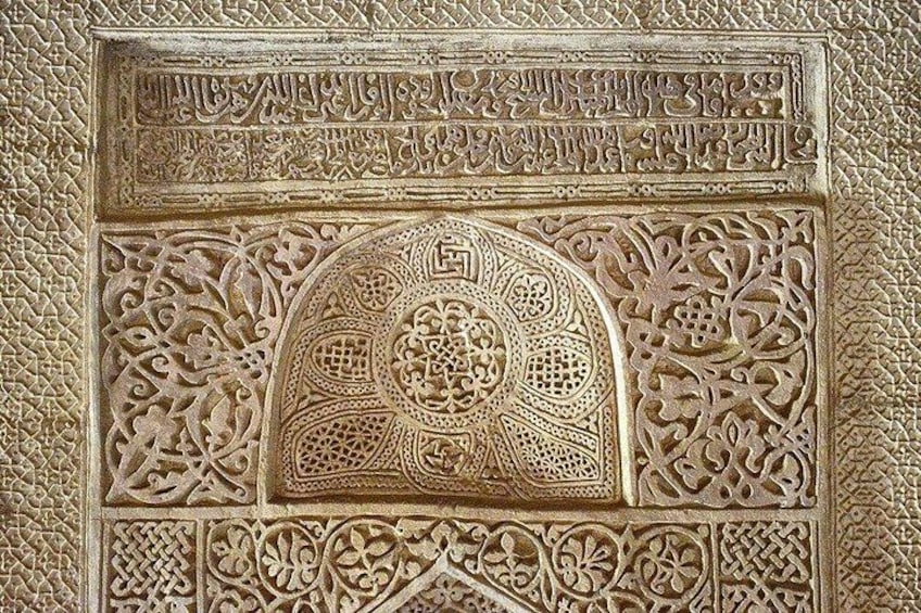 An intricately carved wooden panel with geometric and floral patterns, likely part of a historical or religious structure. 2
