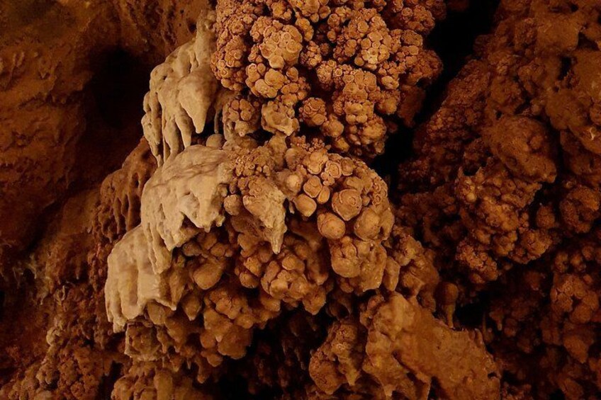 A close-up of a cave formation with stalactites and stalagmites. 2