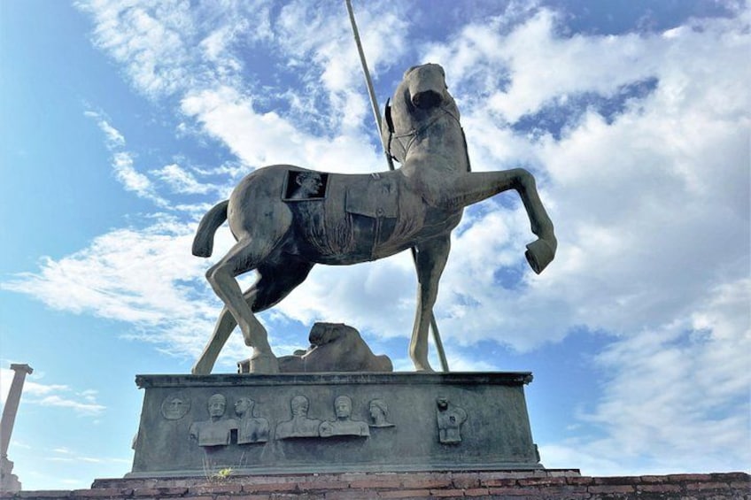 A statue of a horse and rider on a pedestal with inscriptions. 1