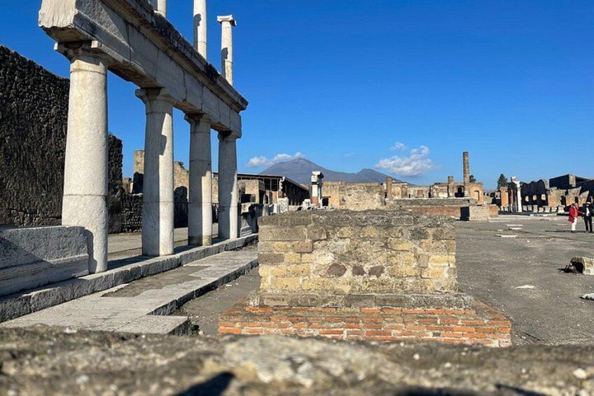 Ancient ruins with columns and a stone platform. 4