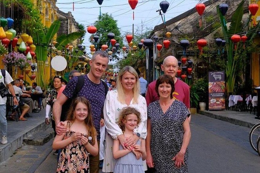A street lined with traditional buildings, adorned with colorful lanterns. 2