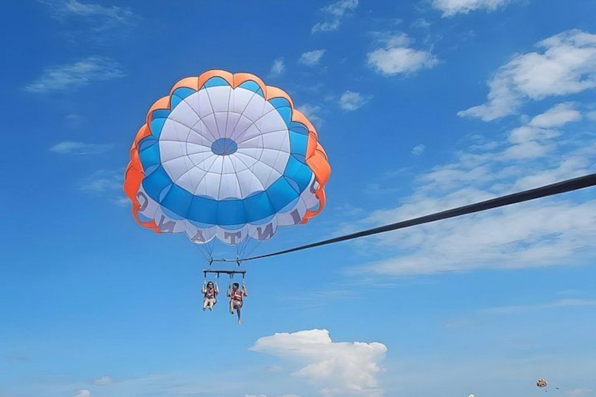 A person skydiving with a parachute. 4