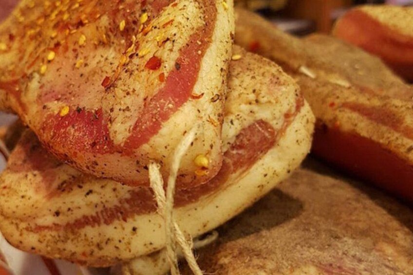 A stack of bread with cheese and bacon. 2