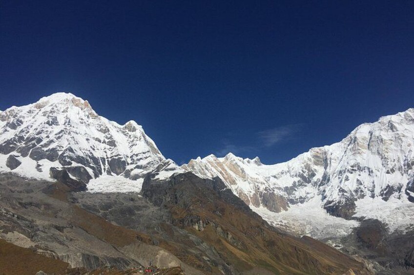 A mountain range with snow-covered peaks under a clear blue sky. 1