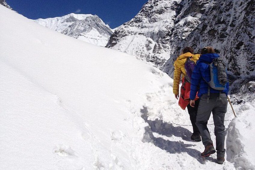 A snowy mountain landscape with hikers. 5