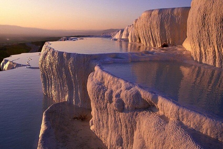 Terraced travertine formations at sunset. 5