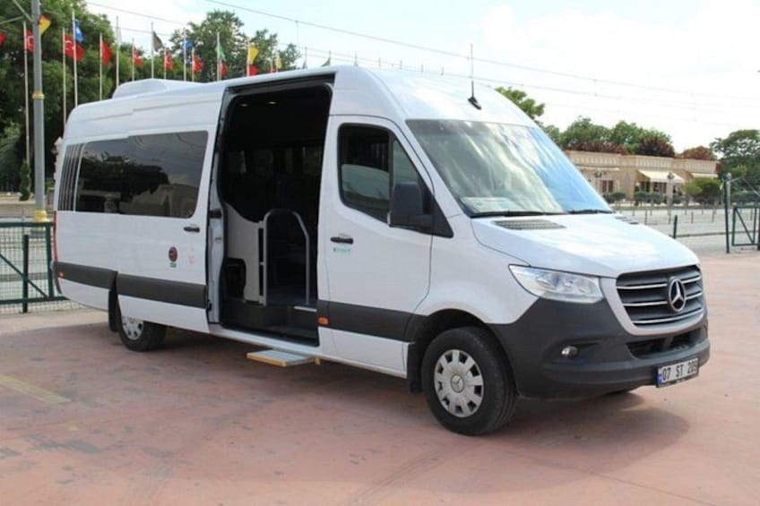 A white Mercedes van parked on a paved surface with its door open, revealing the interior. 4
