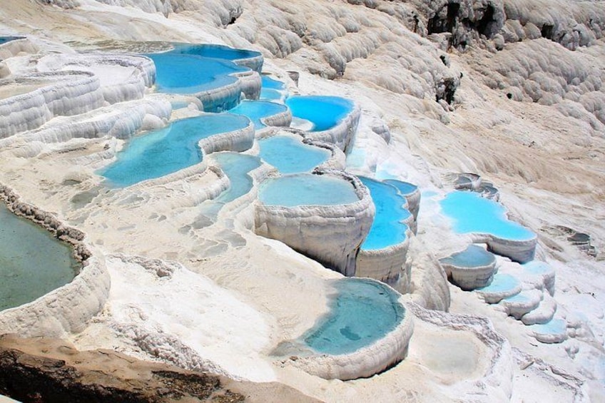 Terraced mineral pools with clear blue water. 1