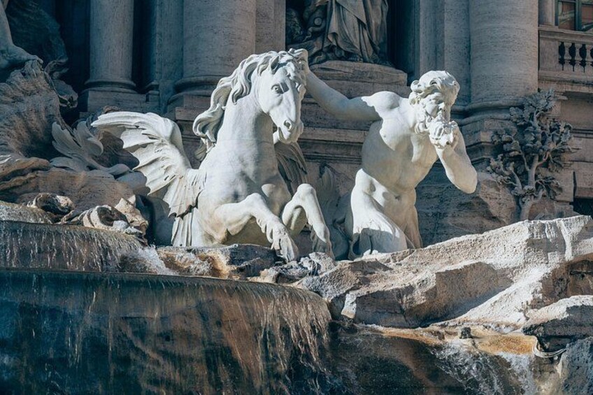 A classical sculpture of a horse and a human figure, set against a backdrop of classical architecture. 1