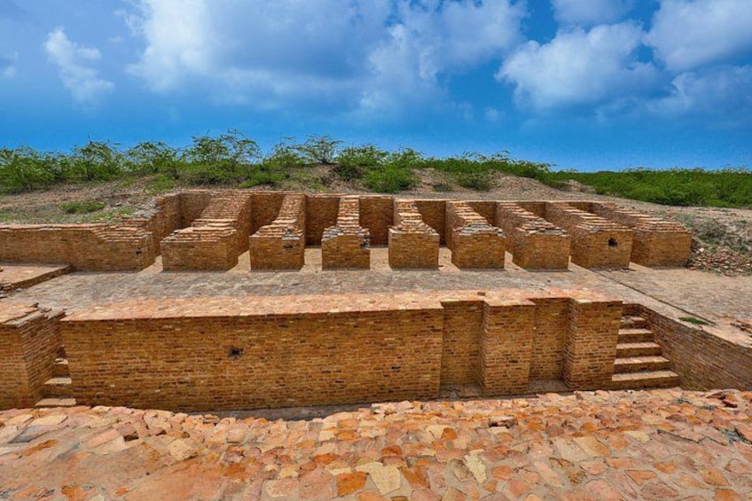 Ancient brick ruins with stepped structures and a staircase leading up to a higher level. 3