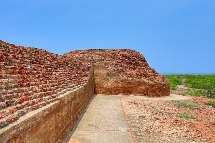 A large brick structure with a pathway leading to a smaller building. 4