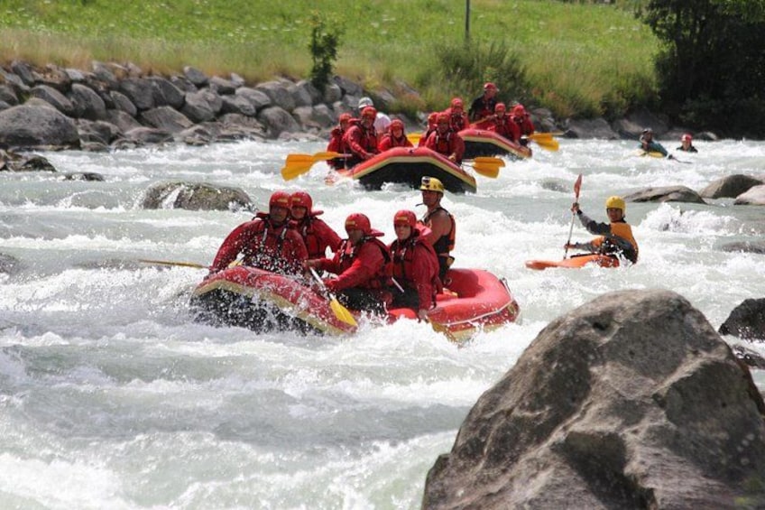 People rafting on a river with rocks and rapids. 4