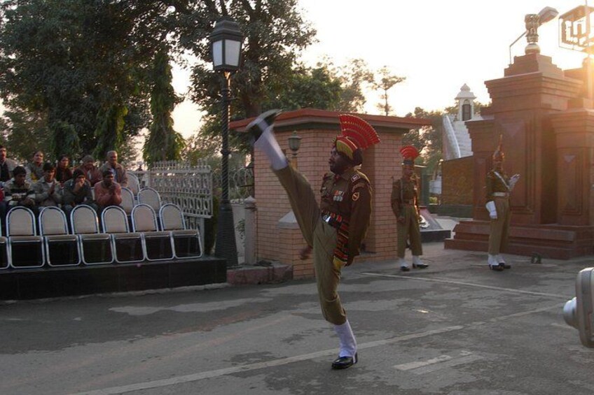 A military parade with soldiers in uniform, a crowd of spectators, and a monument in the background. 3