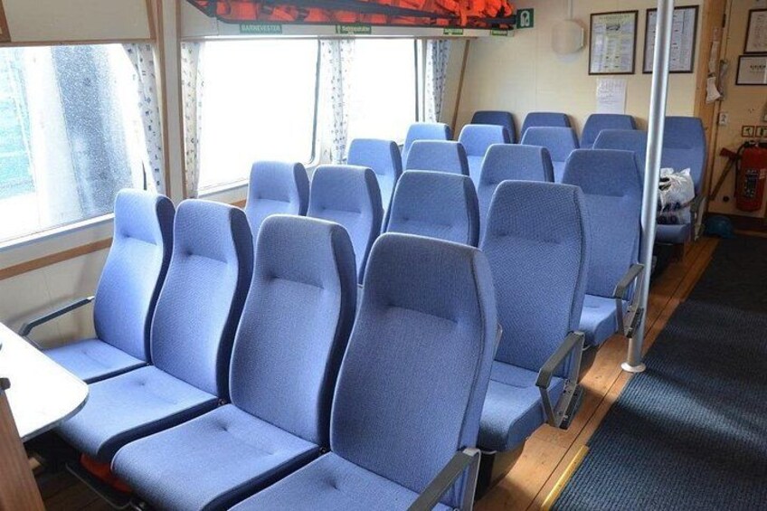A row of blue upholstered seats inside a vehicle. 2