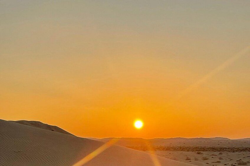 A desert landscape with sand dunes and a sunset. 3