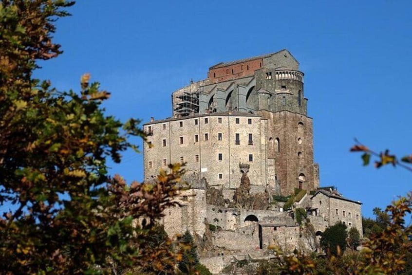 A historic castle with a prominent tower, surrounded by trees. 2
