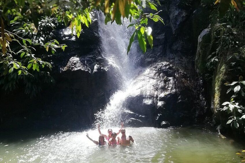 A waterfall, water, and people in a natural setting. 4