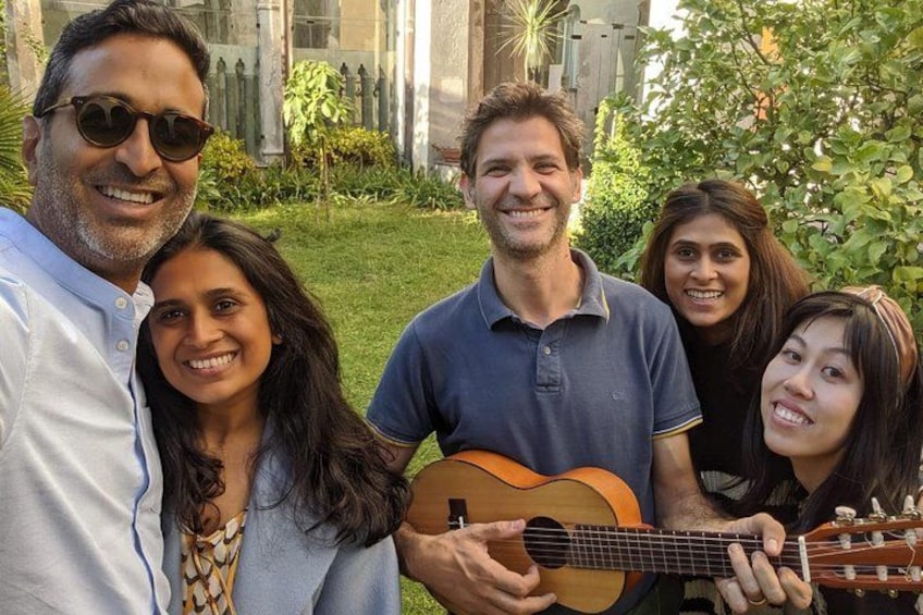 A group of people outdoors with a guitar. 1