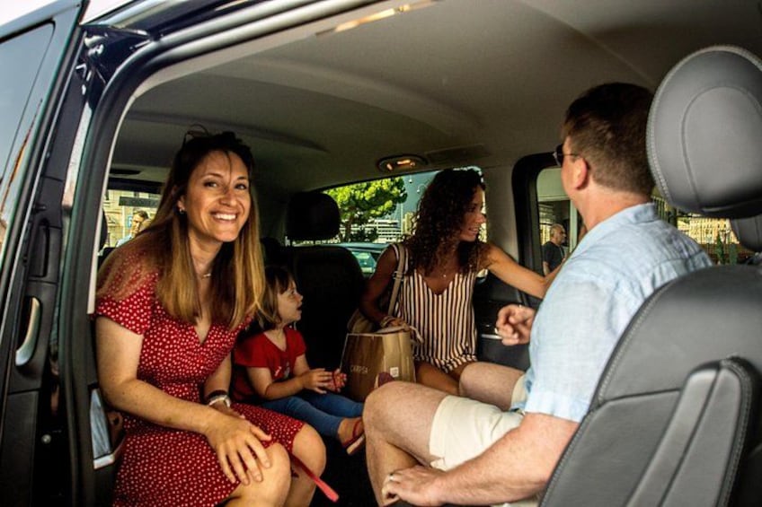 A family inside a van with a child seated in the back. 5