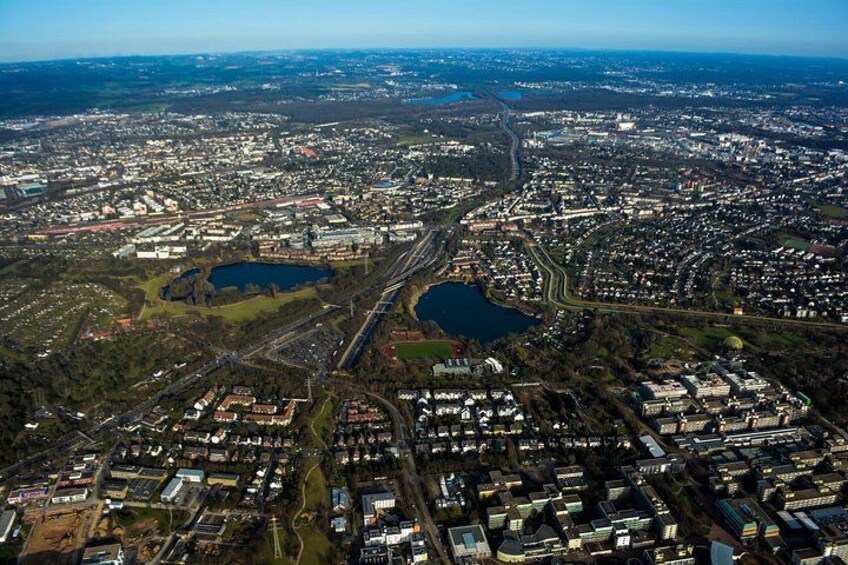 An aerial view of a city with a river, bridges, and surrounding greenery. 3